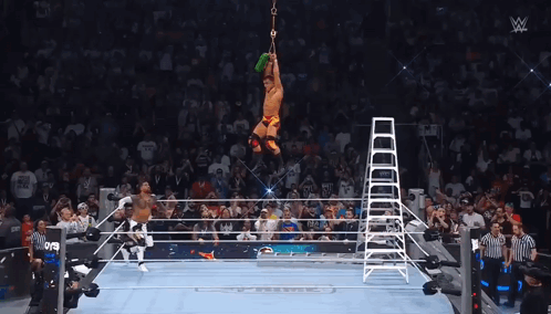 A Wrestler Is Suspended From A Ladder In The Air GIF