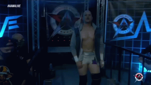 A Wrestler Is Walking Out Of A Ring With The Aawalive Logo In The Background GIF