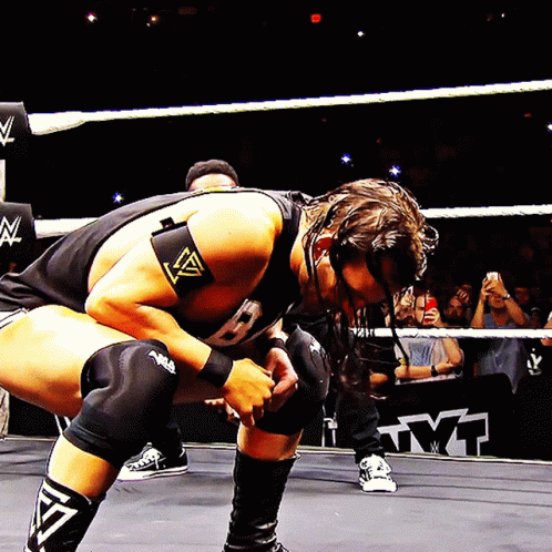 Wrestler Kneeling In Ring With Crowd GIF