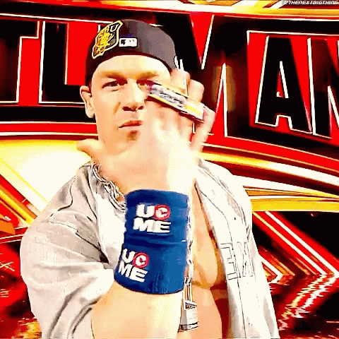 A Wrestler Wearing A Hat And Wristbands That Say Uc On Them GIF