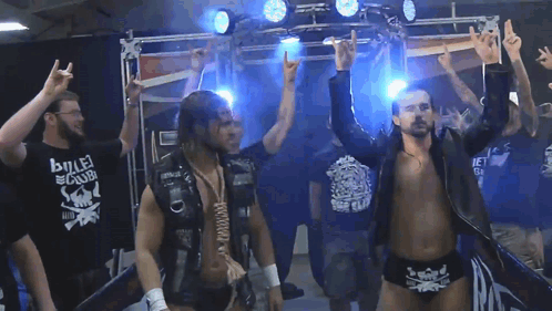 A Wrestler Wearing A Shirt That Says Bullet Club On It GIF