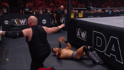 A Wrestler Wearing A Shirt That Says Chaos In Music GIF