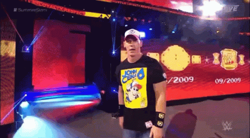 A Wrestler Wearing A Shirt That Says John Cena On It GIF