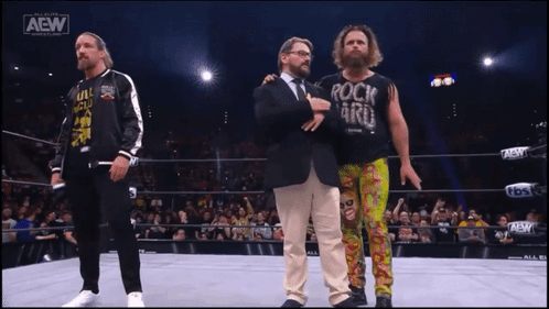 a wrestler wearing a shirt that says rock n ' roll