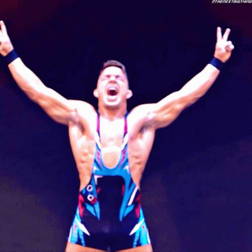 A Wrestler With His Arms Outstretched With The Next Thing Written On The Bottom Right GIF