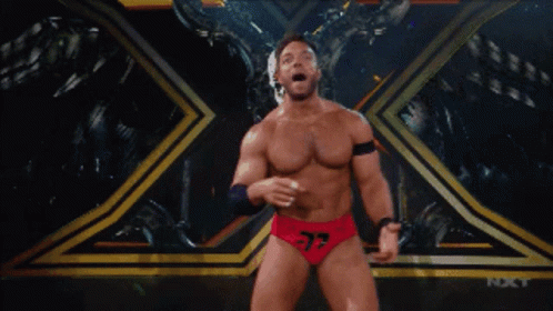 A Wrestler With The Number 37 On His Shorts Stands On A Stage GIF