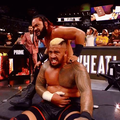 A Wrestling Match Is Being Held In Front Of A Sign That Says Prime Wheat GIF