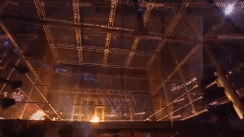 a wrestling ring with flames coming out of the ropes .