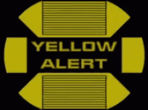 A Yellow And Black Sign That Says Yellow Alert On It GIF