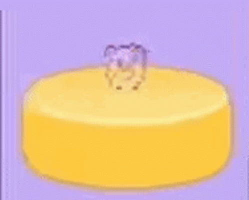 A Yellow Cake With A Teddy Bear On Top Of It . GIF
