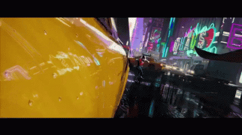 a yellow car is driving down a street with a neon sign that says ' s.p.d. '