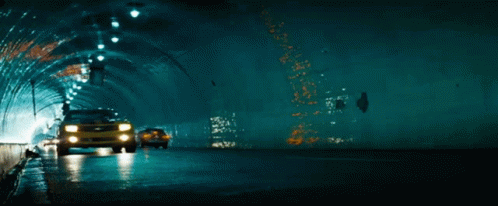 A Yellow Car Is Driving Through A Tunnel GIF