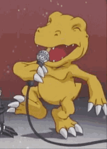 A Yellow Dinosaur Is Singing Into A Microphone While Standing On A Stage . GIF