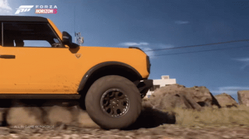A Yellow Ford Bronco Is Driving Down A Dirt Road In Forza Horizon GIF