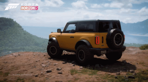 A Yellow Ford Bronco Sits On Top Of A Dirt Hill In A Forza Horizon 5 Video Game GIF