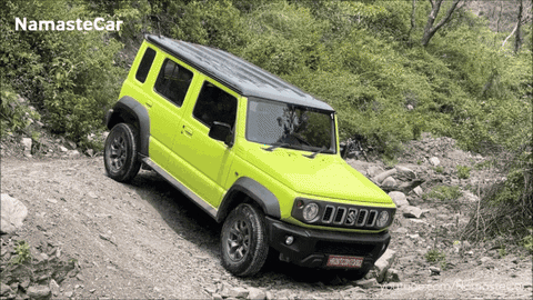 A Yellow Jeep Is Driving Down A Rocky Road With Namaste Car Written On The Bottom GIF