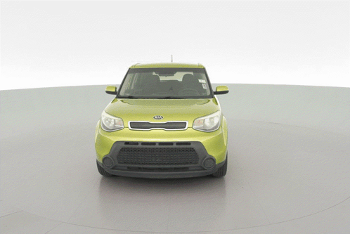 A Yellow Kia Car Is On Display On A White Background GIF