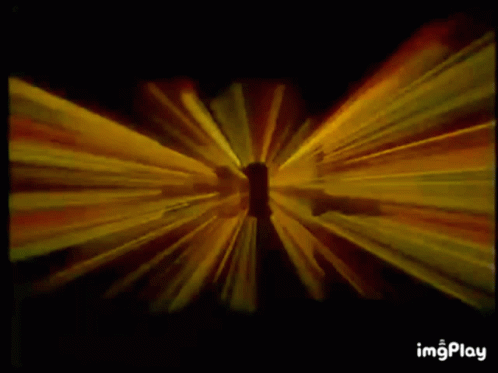 A Yellow Light Beam Is Coming Out Of A Hole In A Black Background GIF