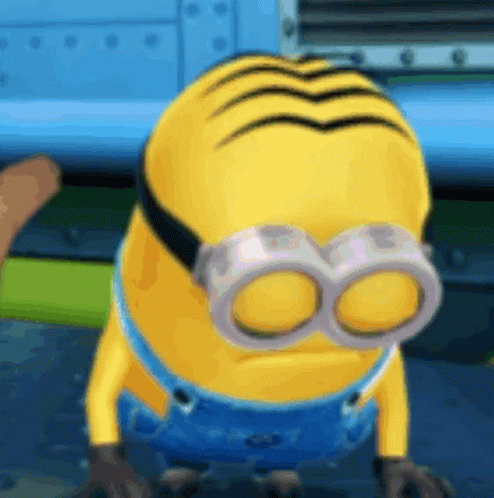 A Yellow Minion Wearing Goggles And Overalls GIF