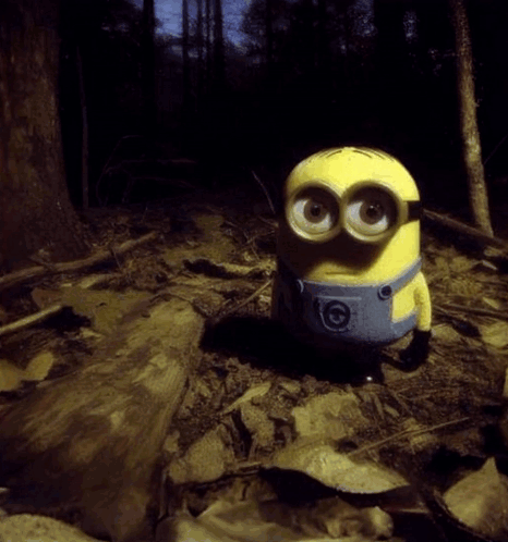 Yellow Minion Sitting In Woods GIF