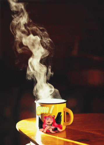 A Yellow Mug With A Picture Of A Girl And The Word Gm On It GIF