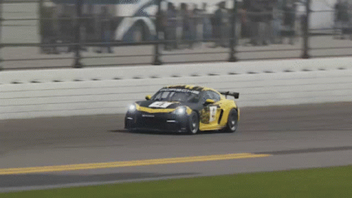 A Yellow Race Car With The Number 17 On The Front GIF