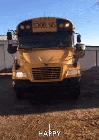 A Yellow School Bus Is Parked In A Dirt Field GIF