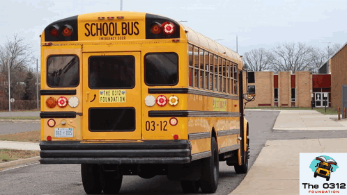 A Yellow School Bus With The 0312 Foundation Written On The Back GIF