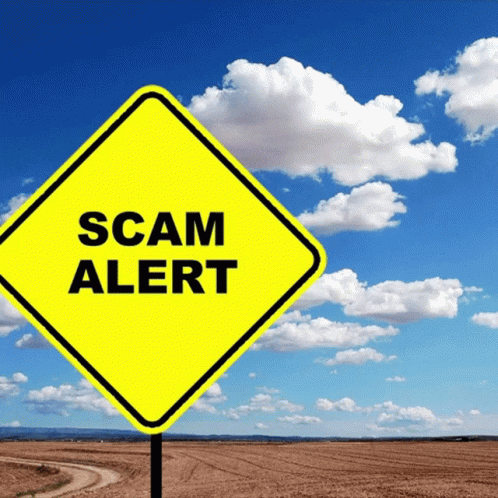 A Yellow Sign That Says Scam Alert In Front Of A Cloudy Sky GIF