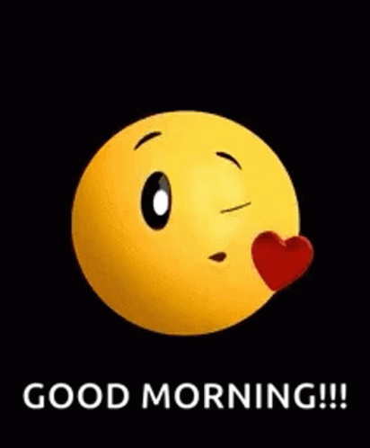 A Yellow Smiley Face Is Blowing A Kiss With A Red Heart On Its Nose . GIF