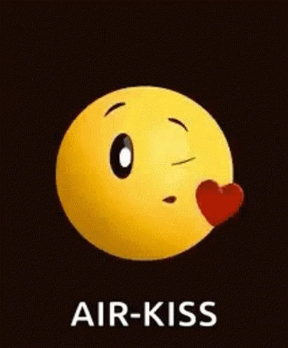 A Yellow Smiley Face Is Blowing A Kiss With A Red Heart . GIF