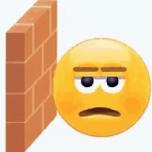 A Yellow Smiley Face With A Sad Face Is Leaning Against A Brick Wall . GIF