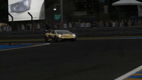 A Yellow Sports Car Is Driving Down A Track GIF