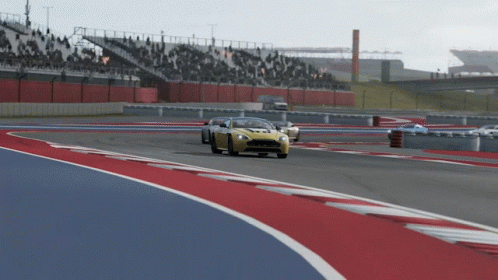 A Yellow Sports Car Is On A Race Track GIF