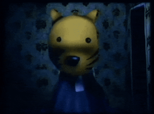 A Yellow Stuffed Animal With A Black Nose Is Standing In A Dark Room GIF