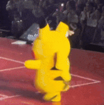 A Yellow Teddy Bear Is Dancing On A Red Floor GIF