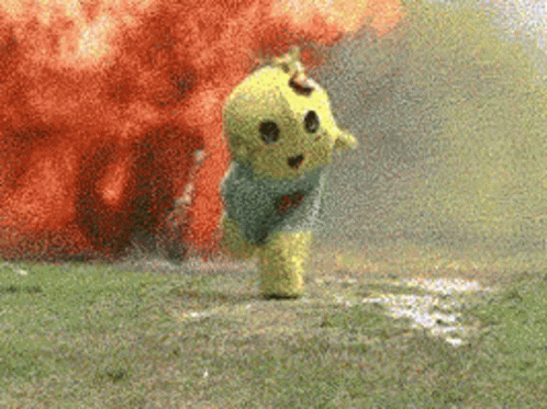 A Yellow Teddy Bear Is Running In Front Of An Explosion In A Field . GIF