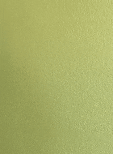 a yellow wall with a white object against it