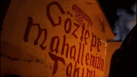 A Yellow Wall With Red Letters That Says Göztepe GIF