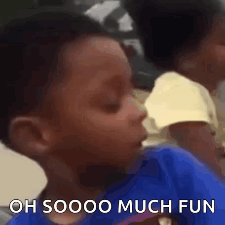 A Young Boy In A Blue Shirt Is Making A Funny Face And Saying `` Oh Soooo Much Fun '' . GIF