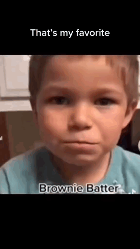 A Young Boy In A Blue Shirt Is Making A Funny Face And Saying `` That 'S My Favorite Brownie Batter '' . GIF