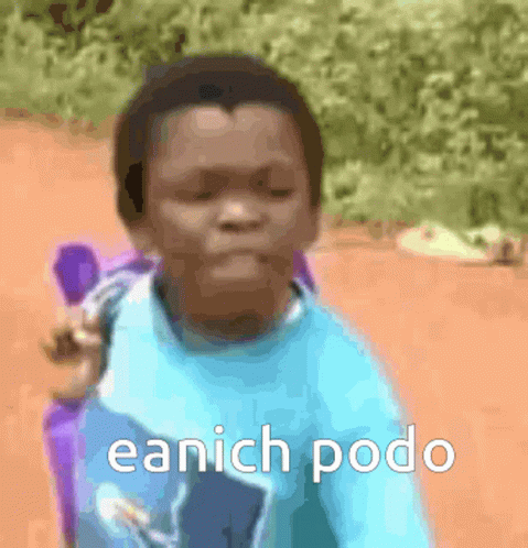 A Young Boy In A Blue Shirt Is Sitting In A Chair With The Words Eanich Podo Written On The Bottom GIF