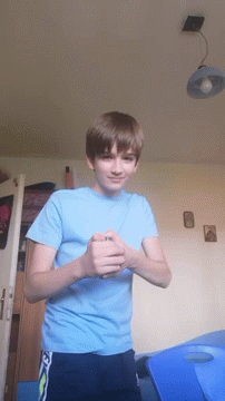 a young boy in a blue shirt with the letter n on it