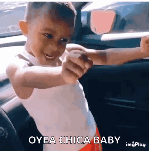 A Young Boy In A Car With The Words Oyea Chica Baby Written On The Bottom GIF