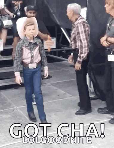 A Young Boy In A Cowboy Outfit Is Standing Next To A Man In A Plaid Shirt With The Words Got Cha Lolgoodnite Below Him GIF
