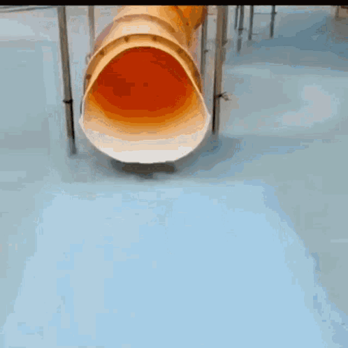 A Young Boy In A Green Shirt Is Playing In A Pool GIF