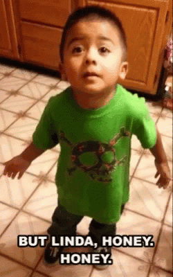 A Young Boy In A Green Shirt With A Skull On It GIF