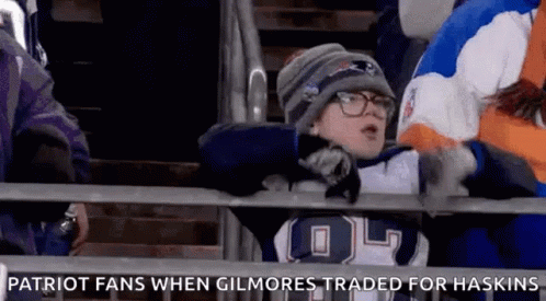 A Young Boy In A Patriots Jersey Is Sitting In The Stands At A Football Game GIF