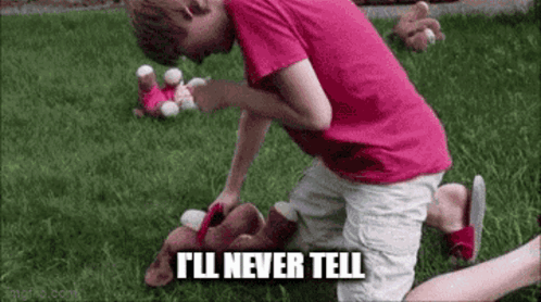 A Young Boy In A Pink Shirt Is Kneeling Down In The Grass With A Stuffed Animal . GIF