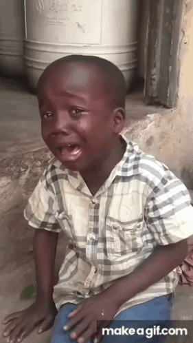 A Young Boy In A Plaid Shirt Is Crying With Tears Running Down His Face GIF